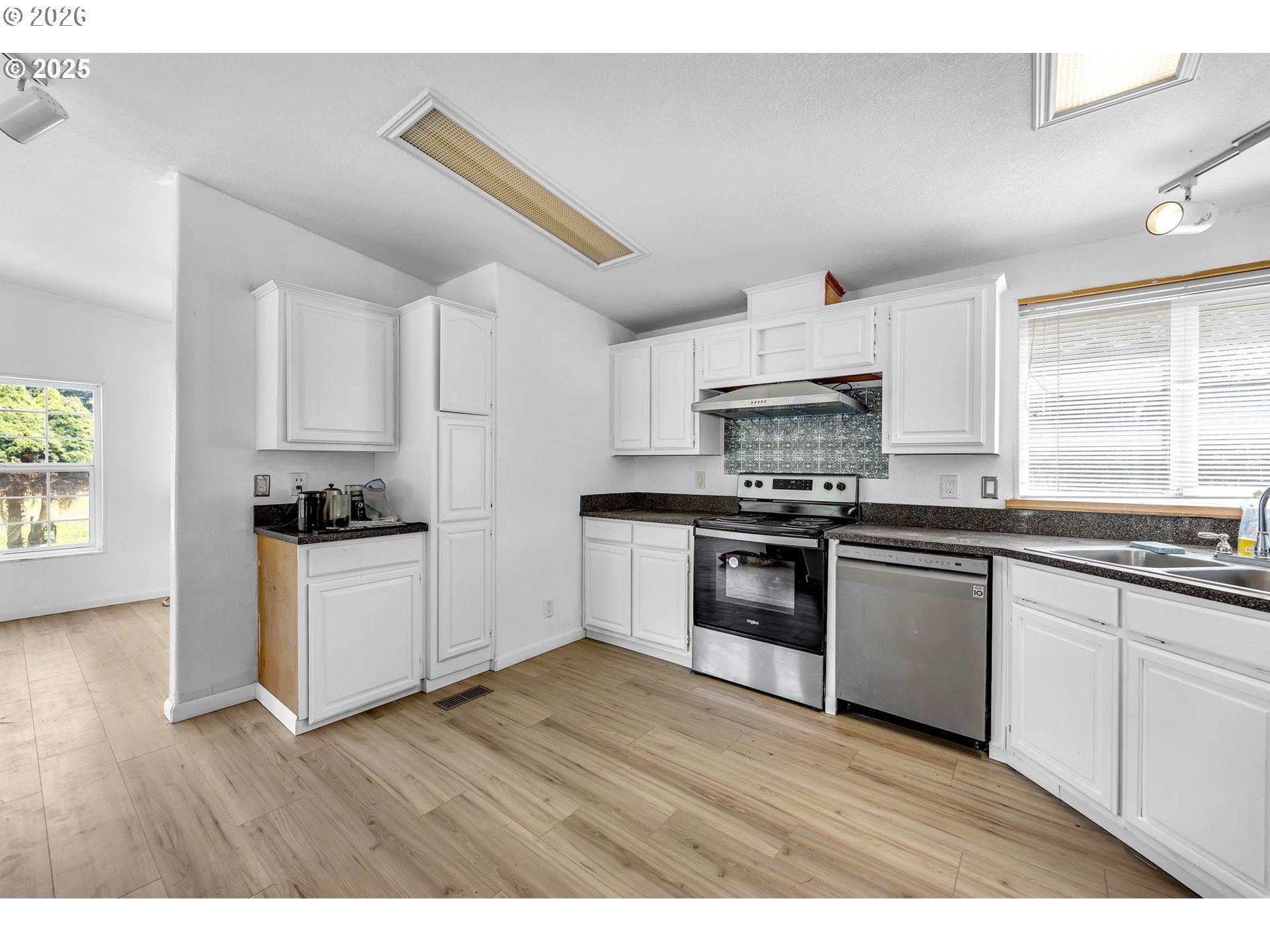241 Foster Creek Road Toledo, WA 98591 - Photo 10 of 17 a kitchen with granite countertop a refrigerator and a stove top oven