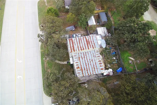 a backyard of a house with table and chairs with wooden fence