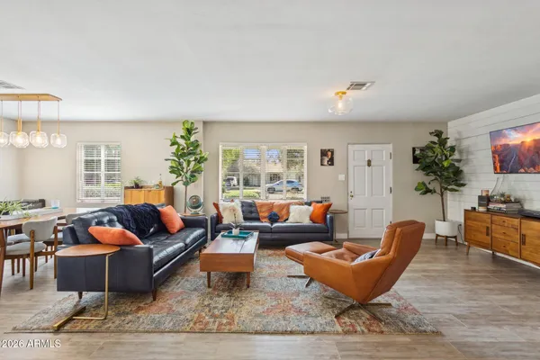 a living room with furniture potted plant and a window