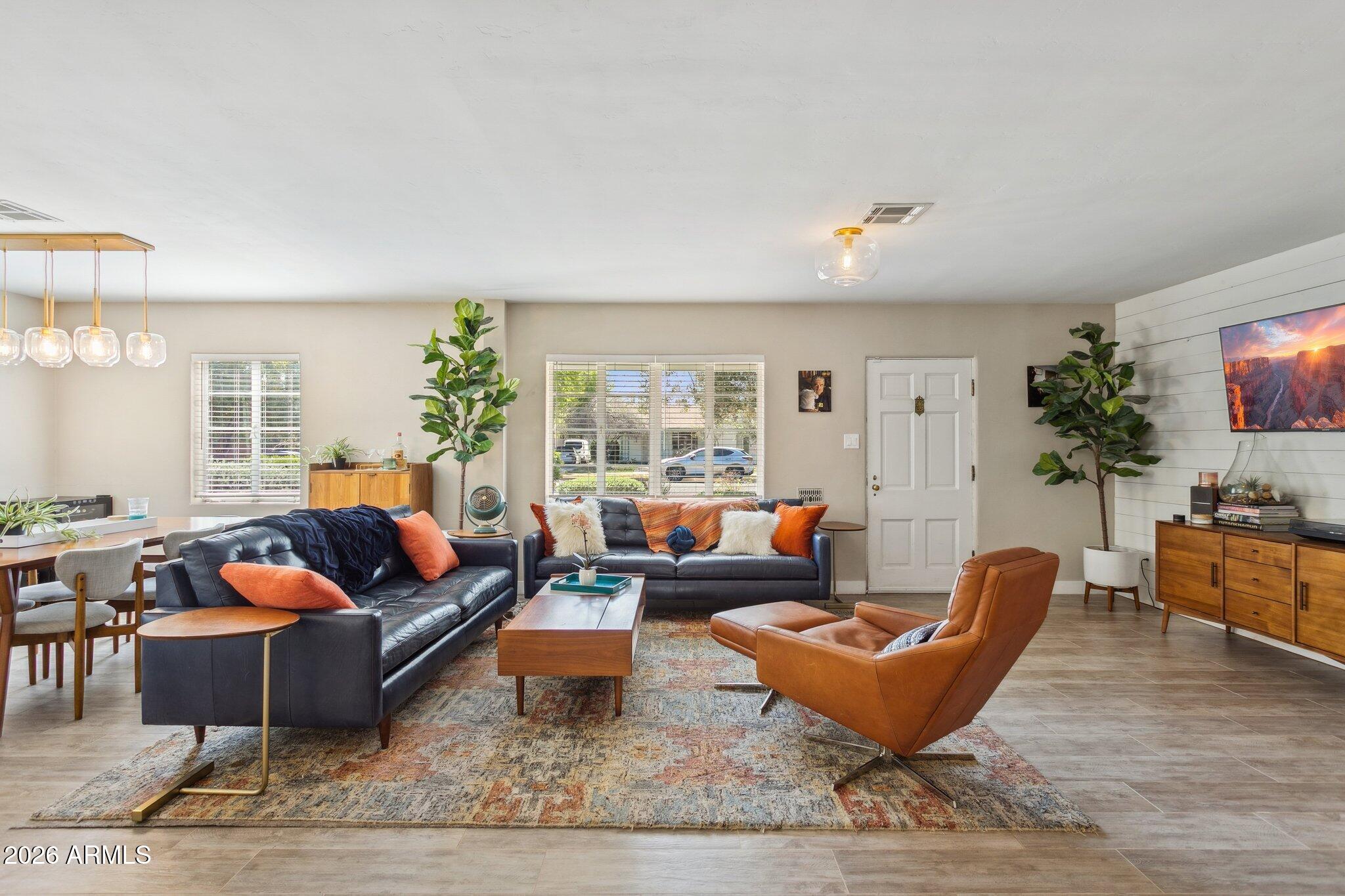 a living room with furniture potted plant and a window