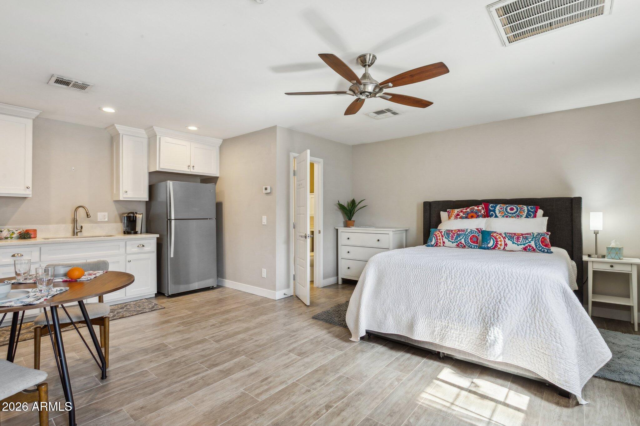 322 West Coronado Road Phoenix, AZ 85003 - Photo 18 of 75 a bedroom with a bed and a chandelier
