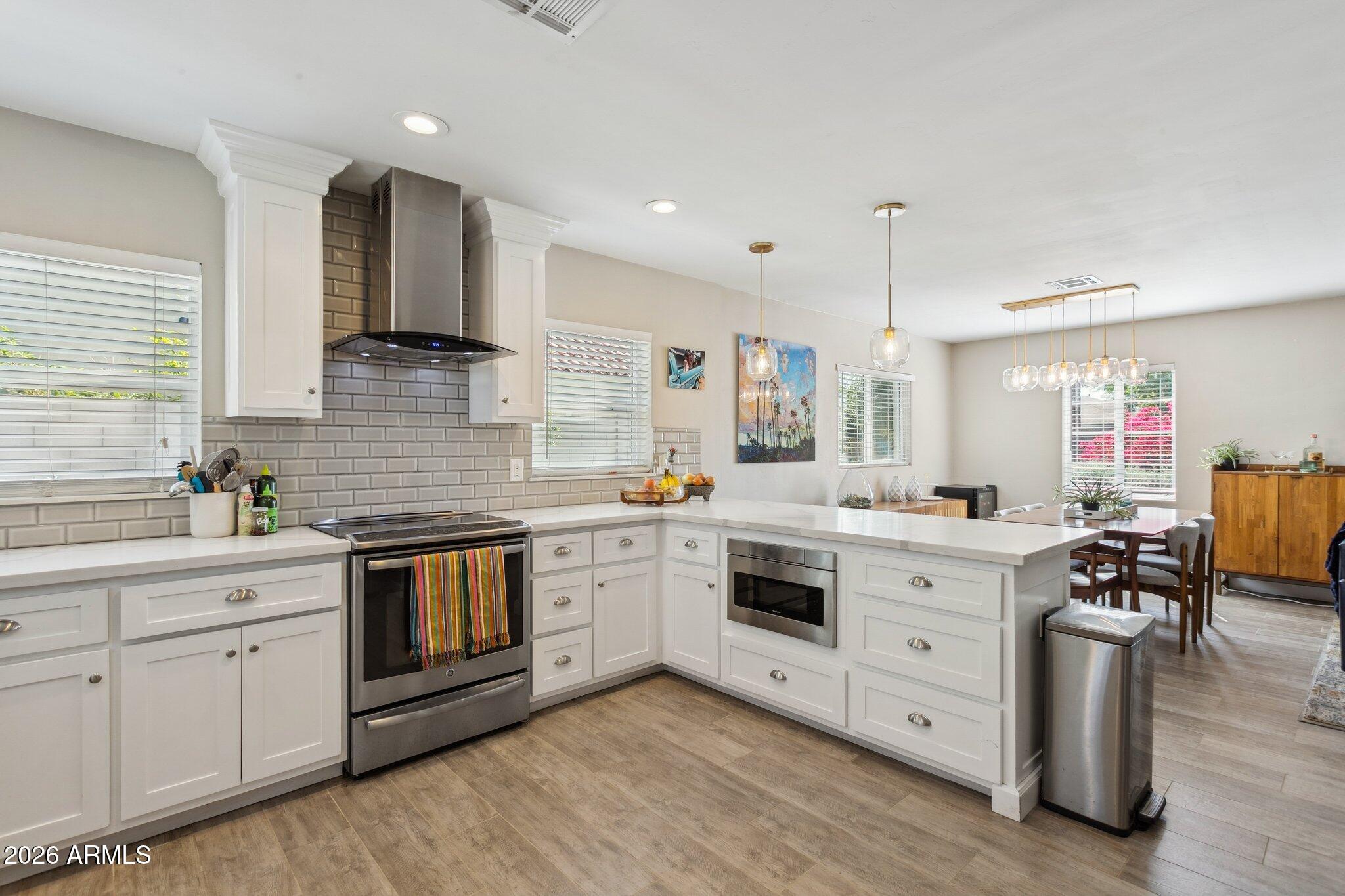 322 West Coronado Road Phoenix, AZ 85003 - Photo 31 of 75 a kitchen with white cabinets stainless steel appliances and sink