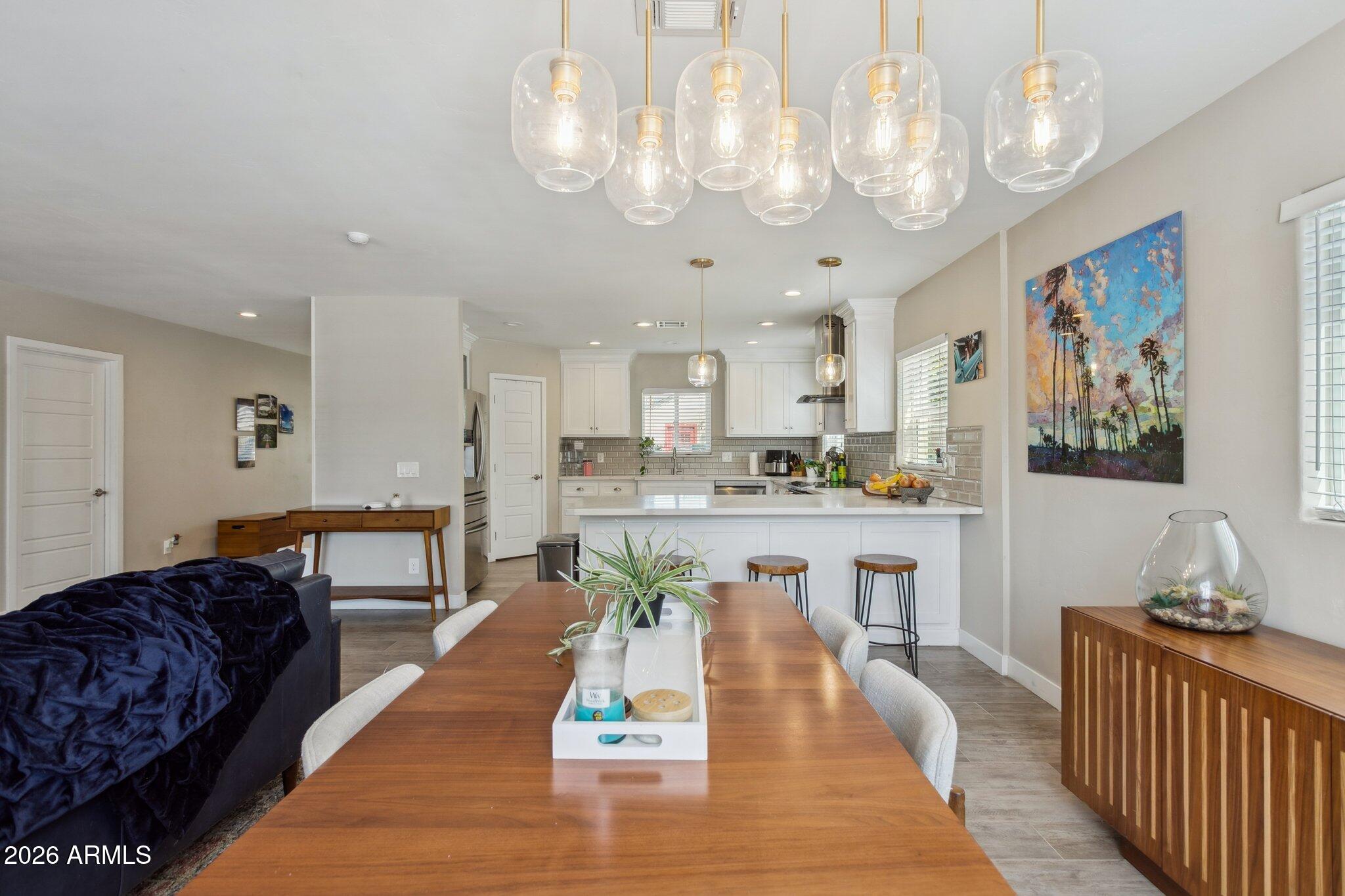 322 West Coronado Road Phoenix, AZ 85003 - Photo 36 of 75 a large kitchen with kitchen island a large counter space a sink appliances and cabinets