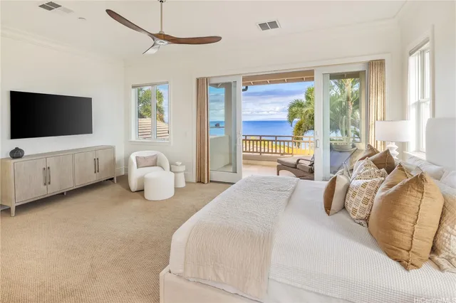 a bedroom with bed and large window