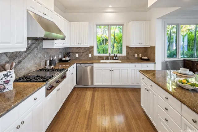 a kitchen with wooden floors and appliances