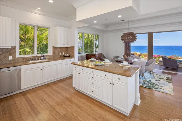 a kitchen with a sink cabinets and wooden floor