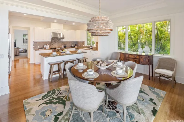 a view of a dining room with furniture wooden floor and chandelier