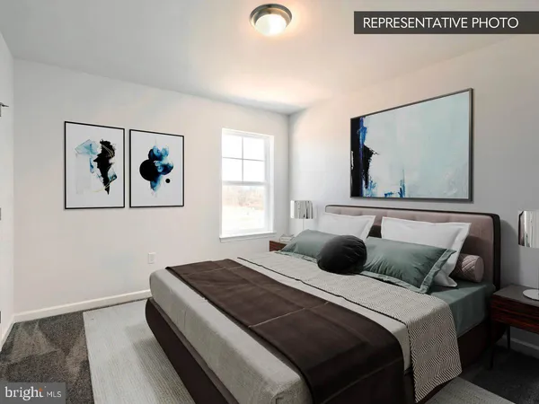 a bedroom with a bed and a painting on the wall