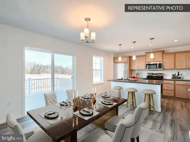 a view of a dining room with furniture a chandelier and wooden floor