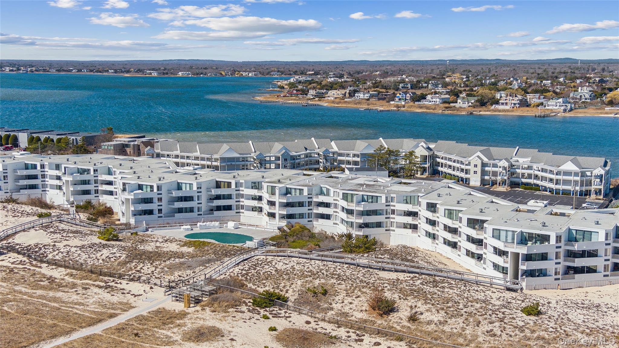 253 Dune Road, Unit 48 Westhampton Beach, NY 11978 - Photo 19 of 28 a view of a lake with a city