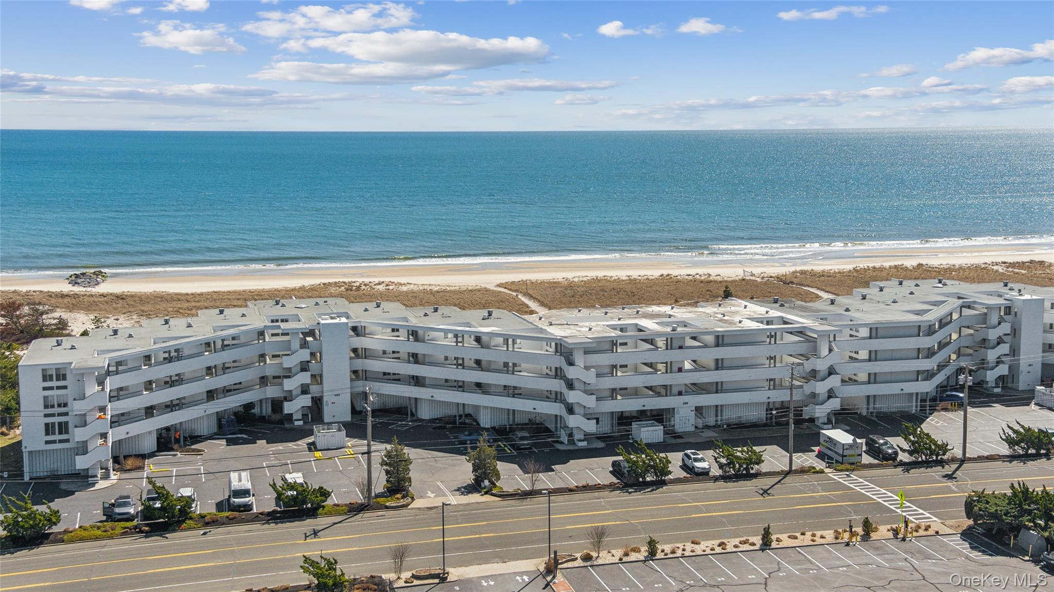 253 Dune Road, Unit 48 Westhampton Beach, NY 11978 - Photo 20 of 28 a view of a building with an ocean view