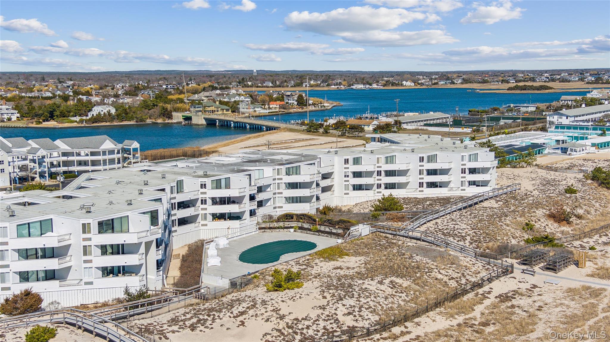253 Dune Road, Unit 48 Westhampton Beach, NY 11978 - Photo 22 of 28 a view of a lake with tall building