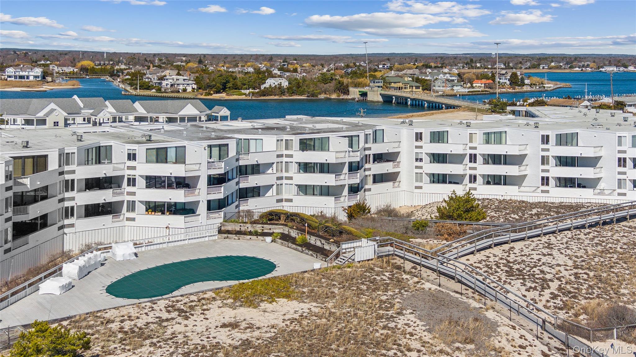 253 Dune Road, Unit 48 Westhampton Beach, NY 11978 - Photo 23 of 28 a view of buildings with ocean view