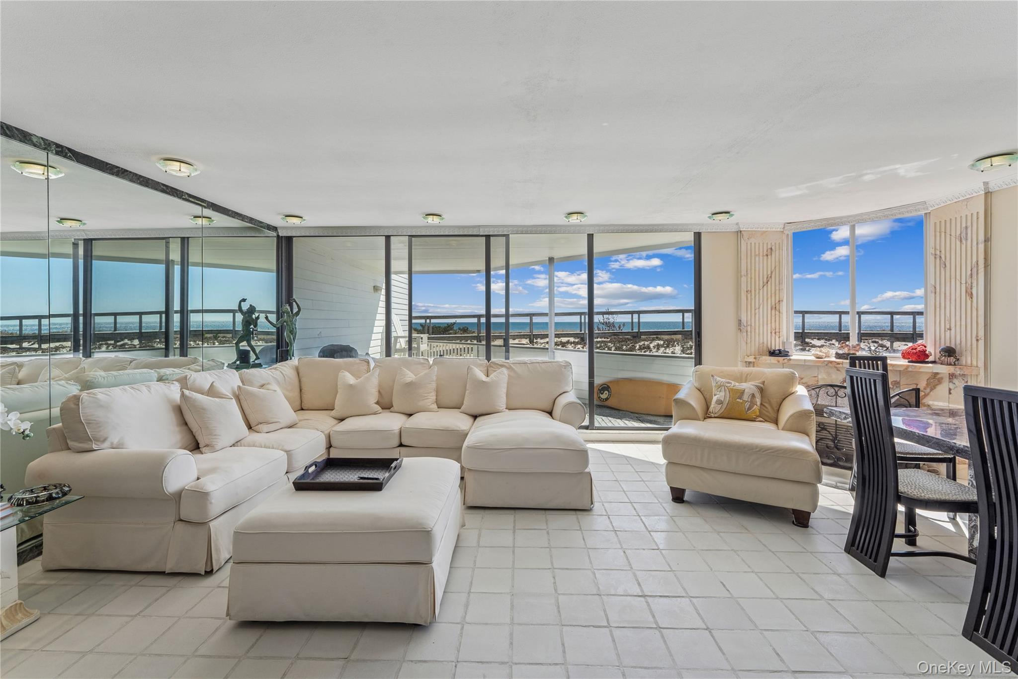 253 Dune Road, Unit 48 Westhampton Beach, NY 11978 - Photo 3 of 28 a living room with furniture and a large window
