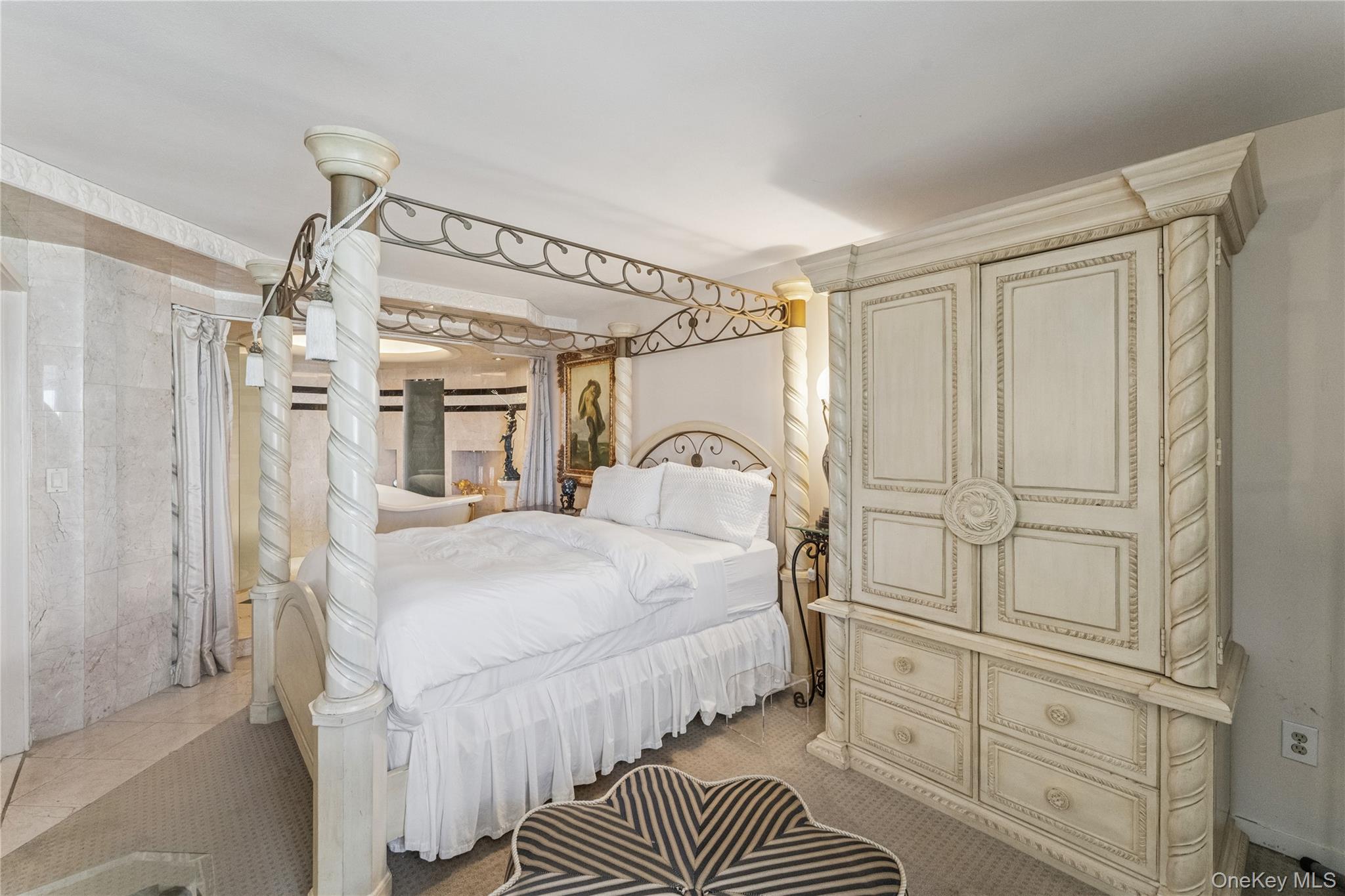 253 Dune Road, Unit 48 Westhampton Beach, NY 11978 - Photo 10 of 28 a bedroom with a bed and a closet with wooden floor