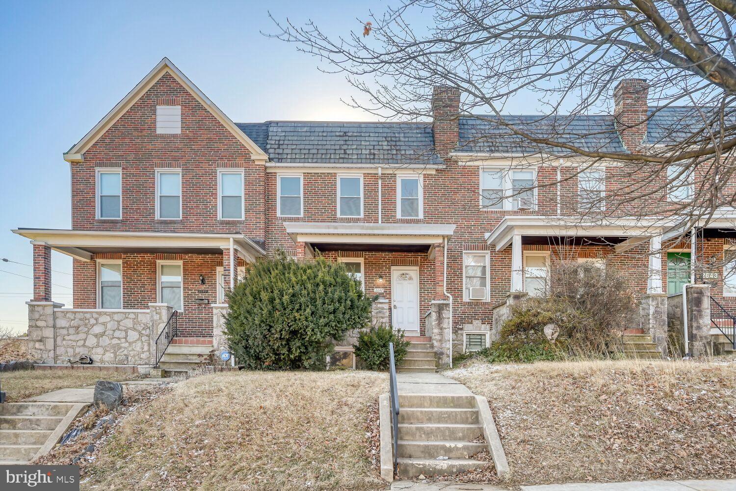 Charming brick townhome with inviting porch.