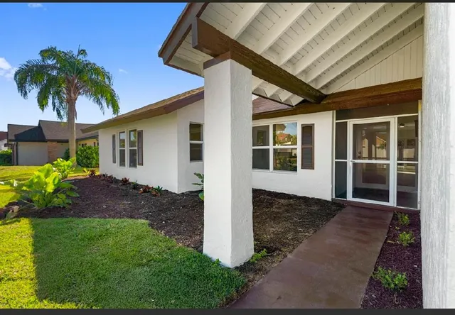 a front view of a house with a garden
