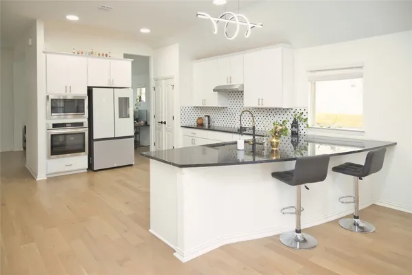 a white refrigerator freezer sitting inside of a kitchen