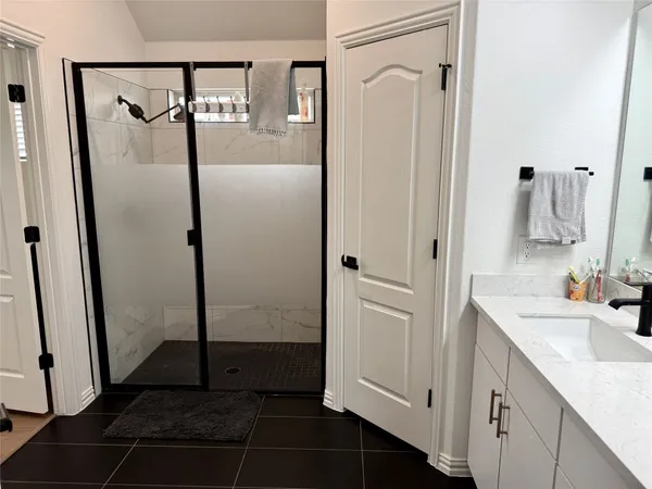 a bathroom with a double vanity sink a mirror a vanity and a shower