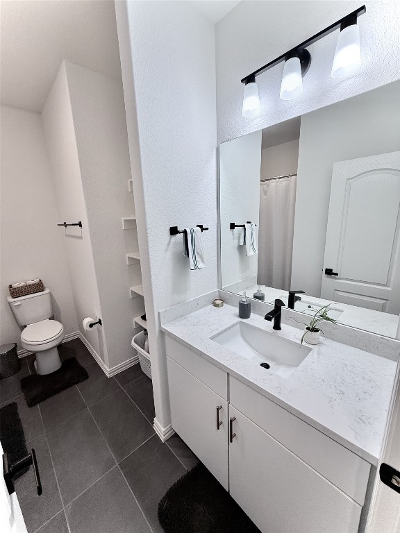 1209 Cole Ests Drive Georgetown, TX 78628 - Photo 19 of 33 Full bath featuring vanity, dark tile patterned flooring, and a shower with shower curtain