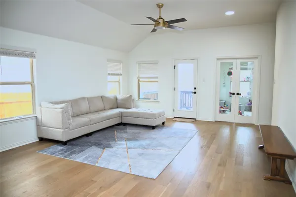 a living room with furniture and a wooden floor