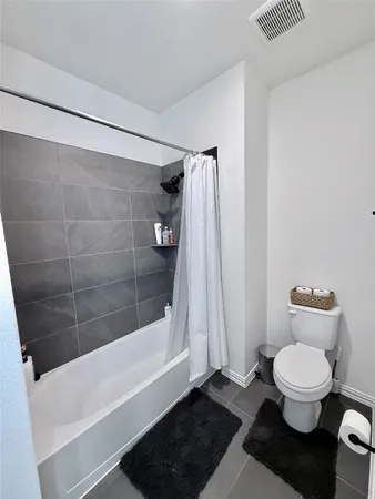 a spacious bathroom with a sink a toilet and a mirror