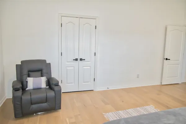 a spacious bedroom with a bed a window and dresser