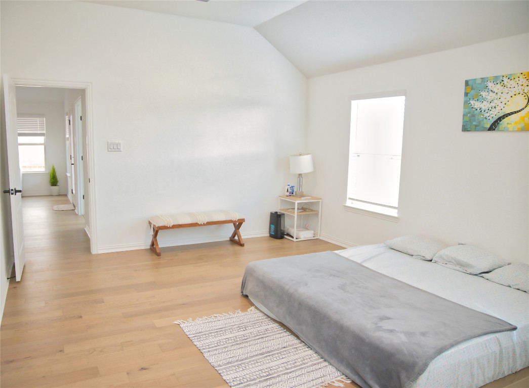 1209 Cole Ests Drive Georgetown, TX 78628 - Photo 25 of 33 Bedroom with light wood-type flooring and vaulted ceiling