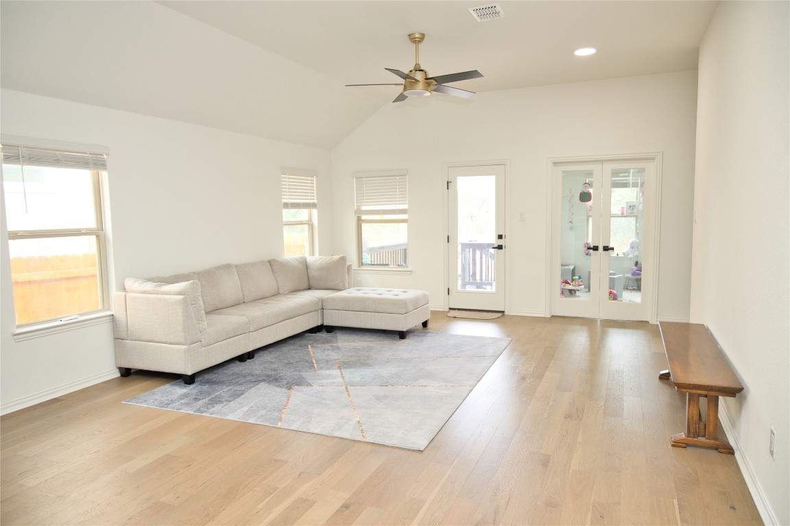 1209 Cole Ests Drive Georgetown, TX 78628 - Photo 3 of 33 Living area with light wood-type flooring, vaulted ceiling, ceiling fan, french doors, and recessed lighting