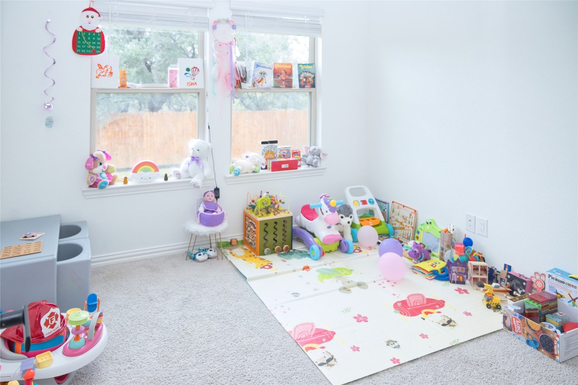 1209 Cole Ests Drive Georgetown, TX 78628 - Photo 30 of 33 Rec room featuring carpet floors and baseboards