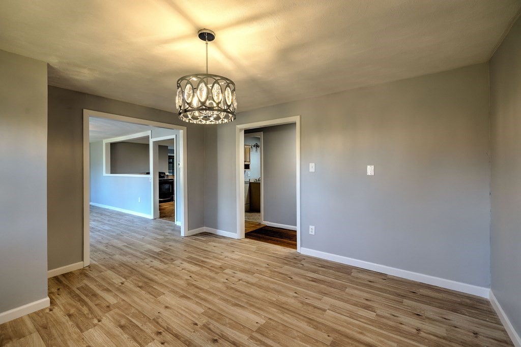 138 Coy Hill Road Warren, MA 01083 - Photo 12 of 42 a view of a hallway with wooden floor and a chandelier