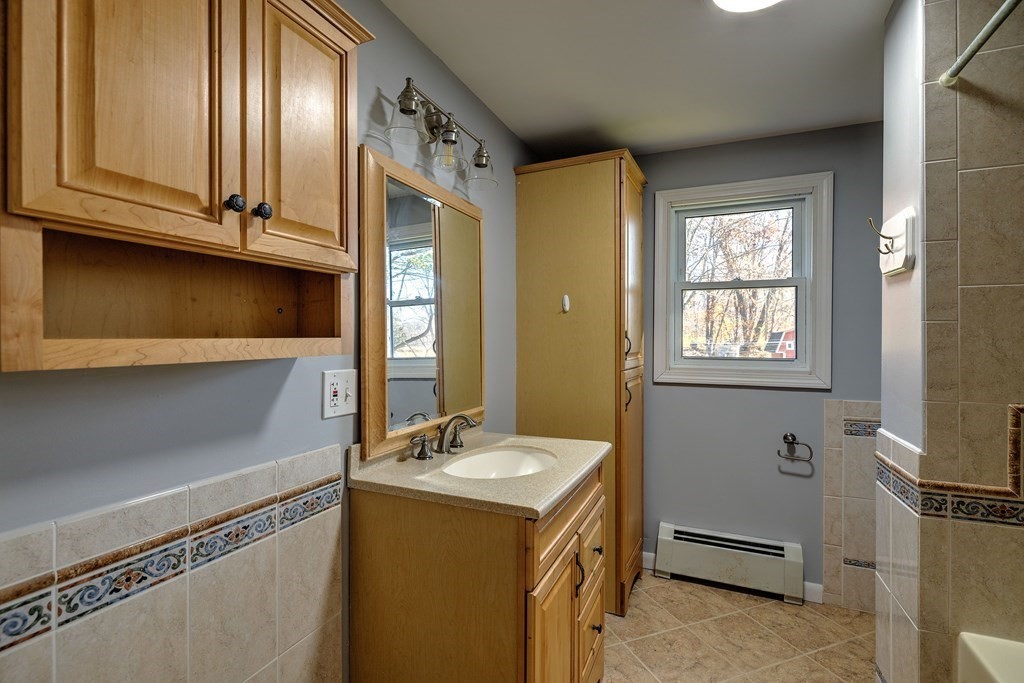 138 Coy Hill Road Warren, MA 01083 - Photo 13 of 42 a bathroom with a sink a mirror and a toilet