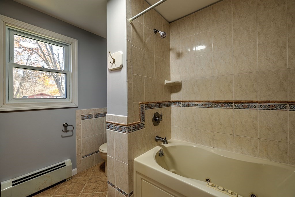 138 Coy Hill Road Warren, MA 01083 - Photo 14 of 42 a bathroom with a bathtub and window