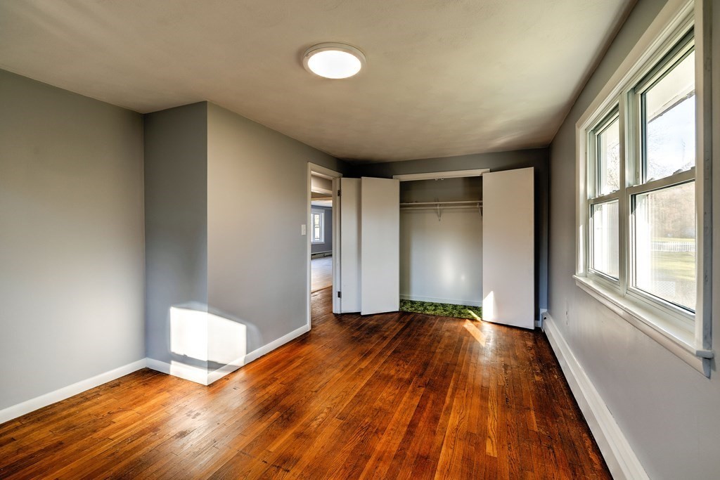 138 Coy Hill Road Warren, MA 01083 - Photo 20 of 42 a view of an empty room with wooden floor and a window