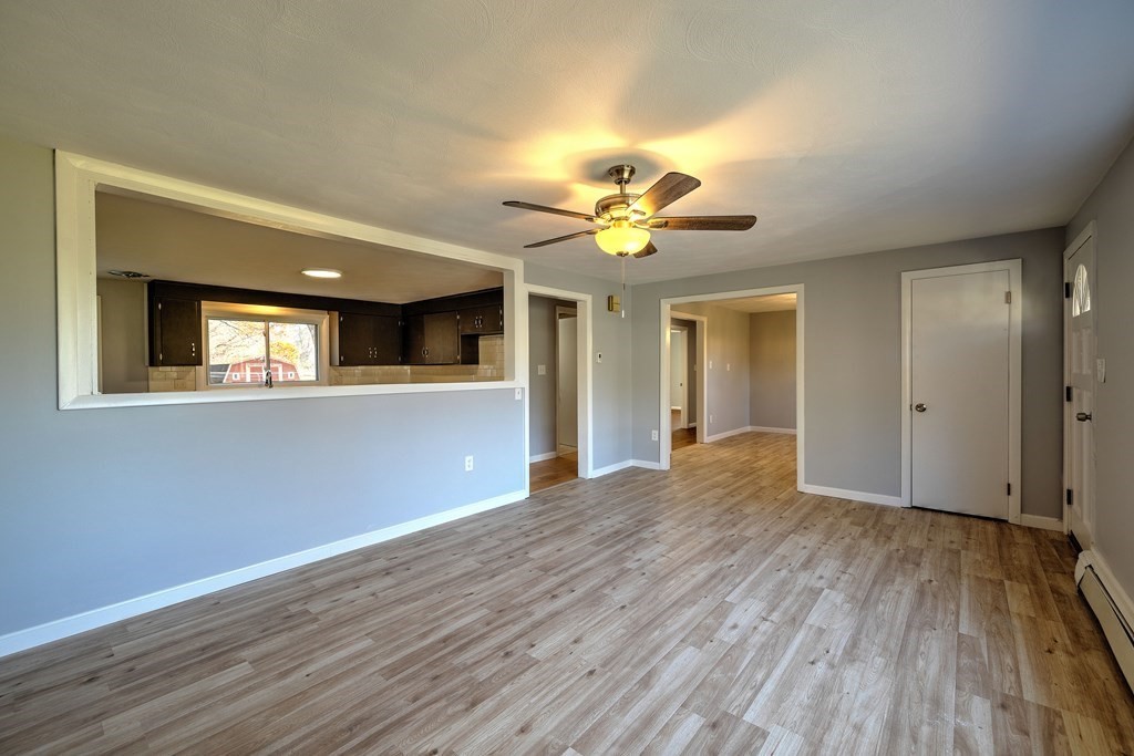 138 Coy Hill Road Warren, MA 01083 - Photo 6 of 42 a view of an empty room with window and wooden floor