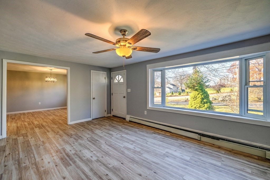138 Coy Hill Road Warren, MA 01083 - Photo 7 of 42 a view of an empty room with window and wooden floor