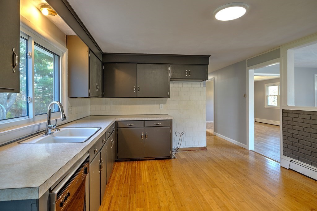 138 Coy Hill Road Warren, MA 01083 - Photo 9 of 42 a kitchen with a sink a stove and a microwave oven