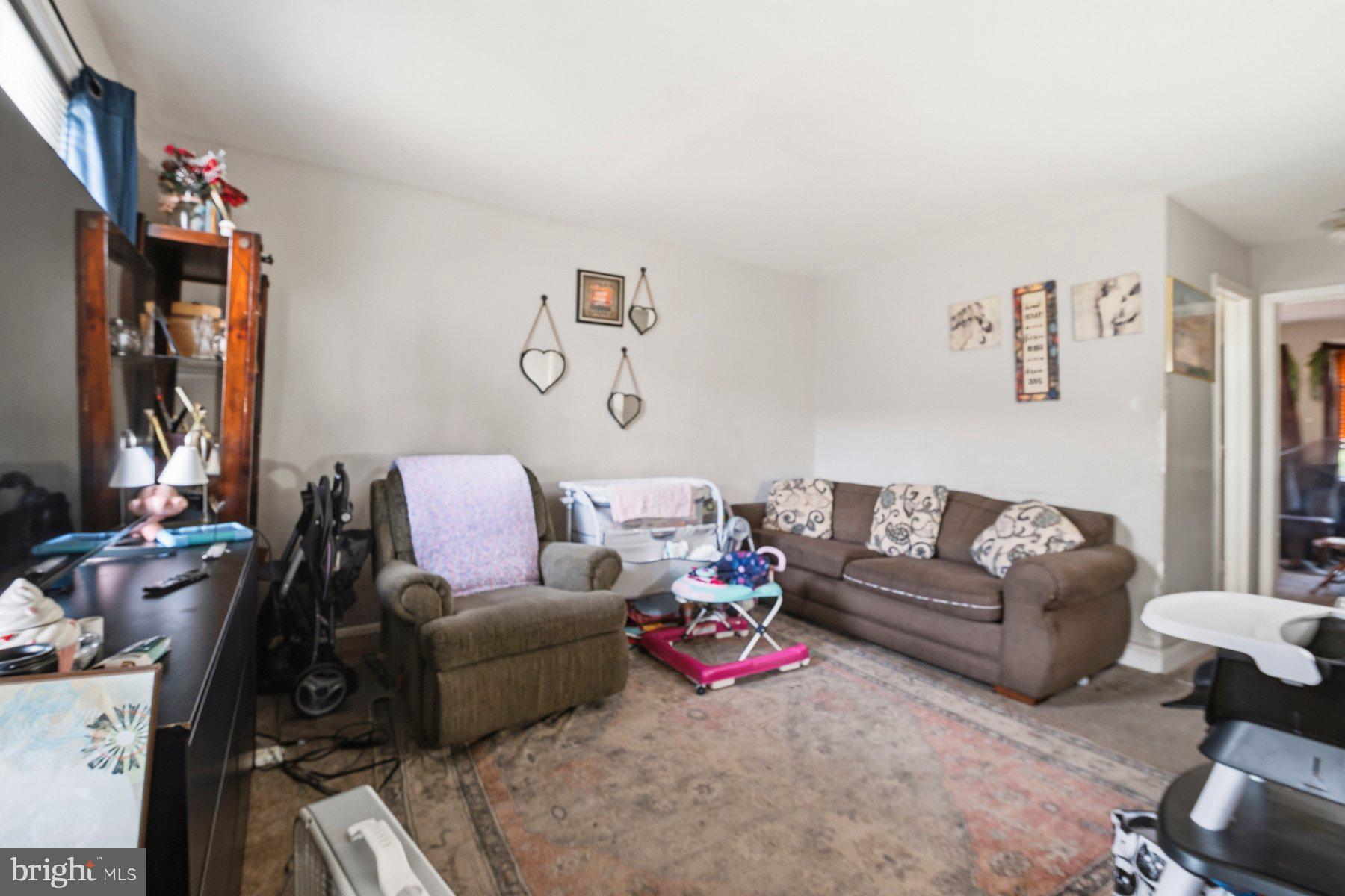 4931 Brookwood Road Baltimore, MD 21225 - Photo 3 of 25 a living room with furniture and a couch