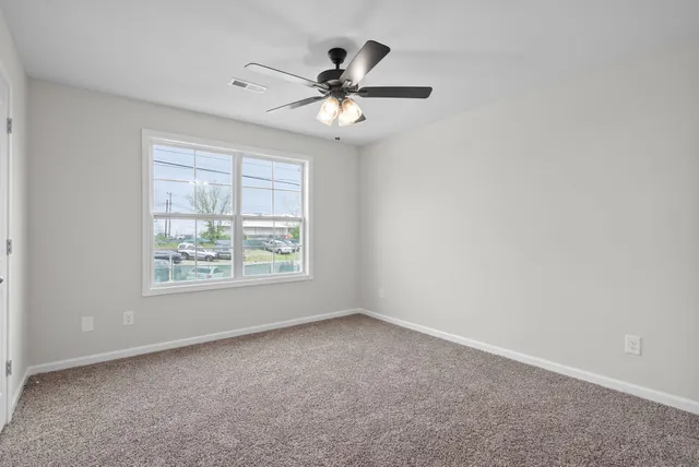 a bathroom with a granite countertop toilet sink and mirror