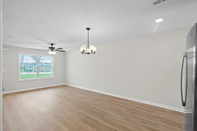 wooden floor in an empty room with a staircase