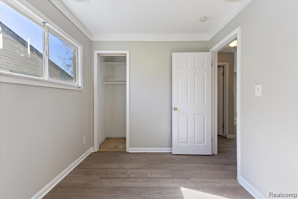 26076 Colgate Street Inkster, MI 48141 - Photo 20 of 24 Room featuring wood-finish flooring, light gray wall paint, and white trim