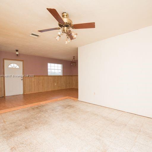 10391 Southwest 156th Street Miami, FL 33157 - Photo 13 of 33 an empty room with chandelier fan and windows