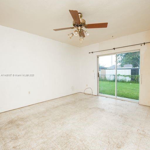 10391 Southwest 156th Street Miami, FL 33157 - Photo 14 of 33 an empty room with a ceiling fan and a window