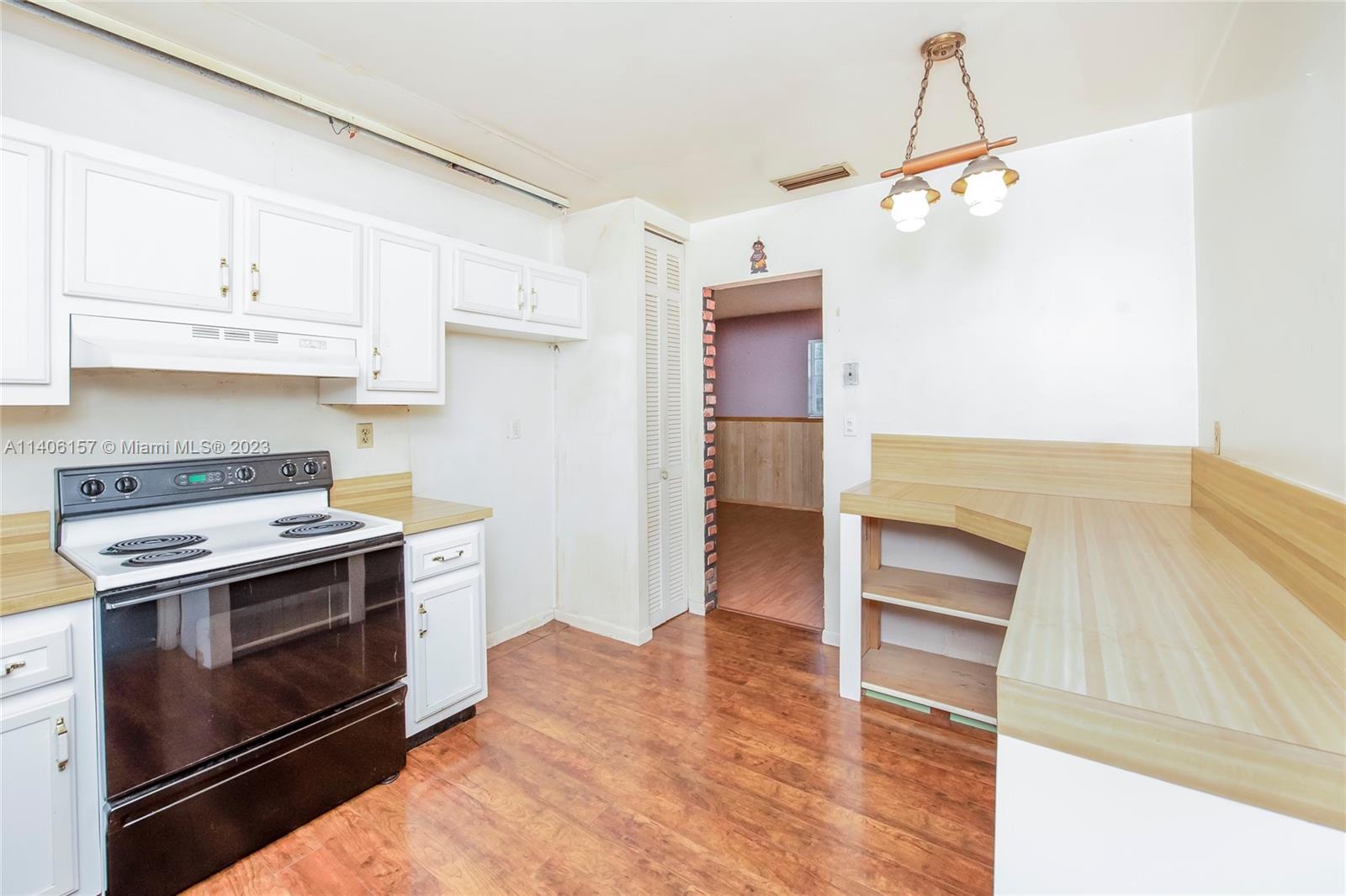 10391 Southwest 156th Street Miami, FL 33157 - Photo 19 of 33 a kitchen with a stove and a microwave