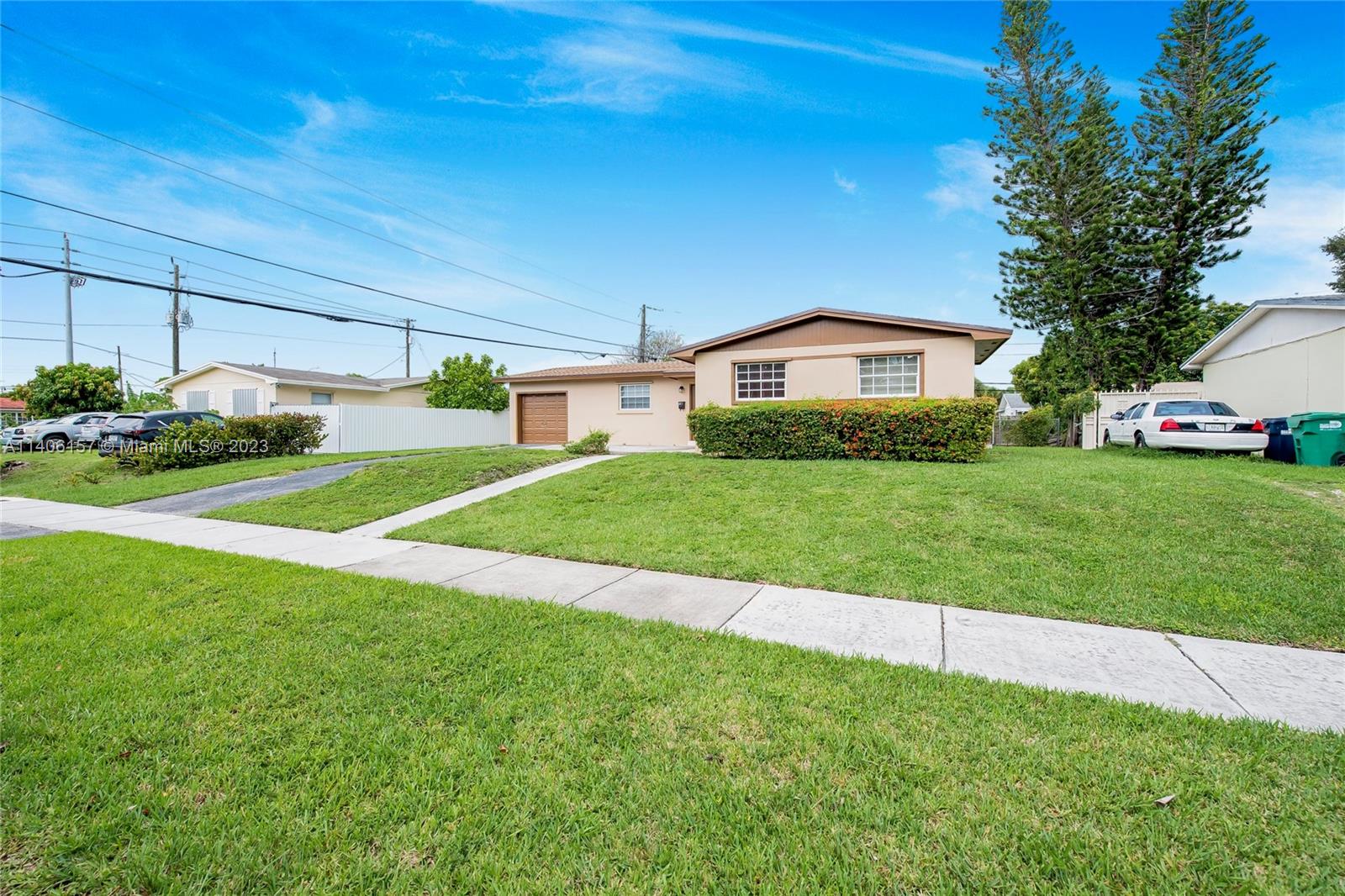 10391 Southwest 156th Street Miami, FL 33157 - Photo 2 of 33 a view of a house with a big yard and potted plants