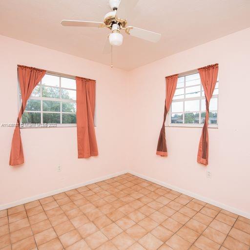 10391 Southwest 156th Street Miami, FL 33157 - Photo 26 of 33 a bedroom with a bed and a window
