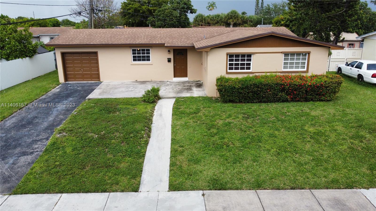 10391 Southwest 156th Street Miami, FL 33157 - Photo 30 of 33 a front view of a house with a yard and garage