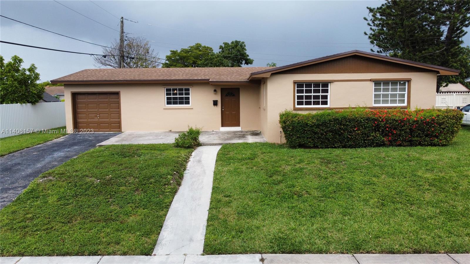 10391 Southwest 156th Street Miami, FL 33157 - Photo 4 of 33 a front view of a house with a yard