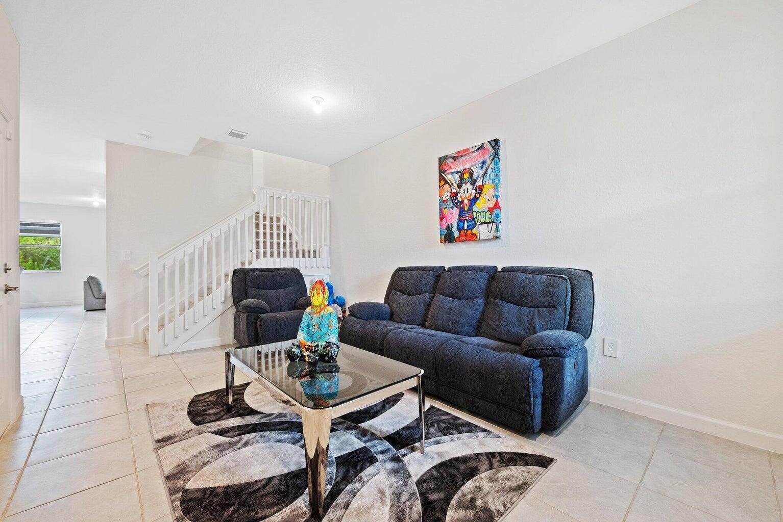 2701 Southeast 10th Street Homestead, FL 33035 - Photo 2 of 23 a living room with furniture a rug and a table
