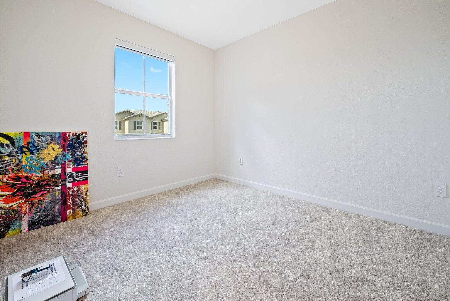 2701 Southeast 10th Street Homestead, FL 33035 - Photo 22 of 23 an empty room with a window and storage space